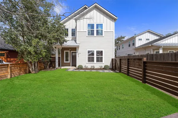 a view of a house with a yard and sitting area