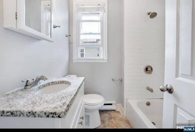a bathroom with a sink toilet and tub