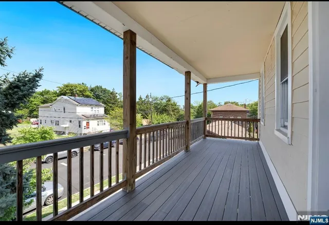 a view of a balcony with wooden floor