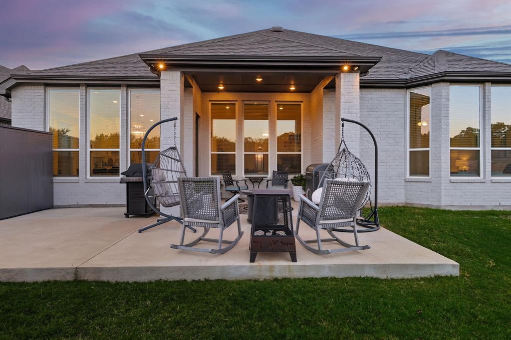 4608 Mount Vista Road Oak Point, TX 75068 - Photo 37 of 39 Exterior patio featuring a covered seating area, concrete slab, and an adjacent green lawn