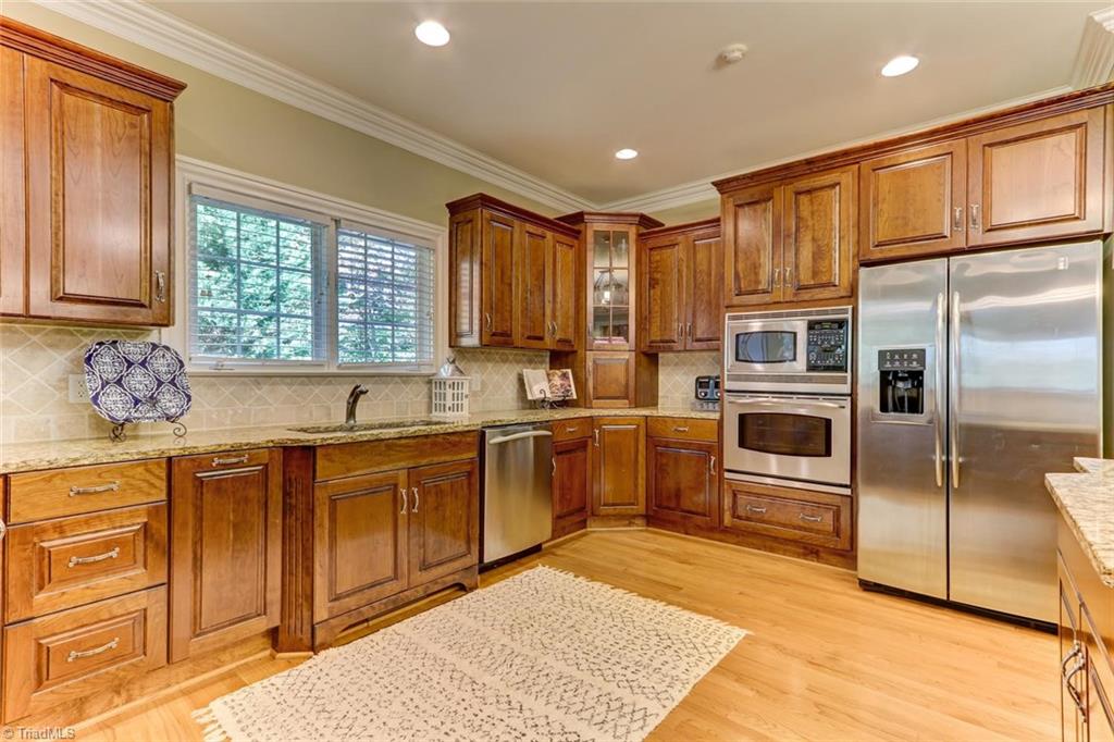 4905 Leadenhall Road Oak Ridge, NC 27310 - Photo 8 of 30 Custom cabinetry in the extra large kitchen.