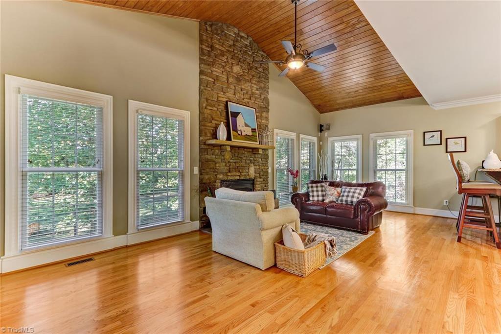 4905 Leadenhall Road Oak Ridge, NC 27310 - Photo 10 of 30 Keeping room highlighted by vaulted wood ceiling and floor to ceiling stone fireplace.