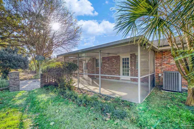 a view of a porch with furniture and garden view