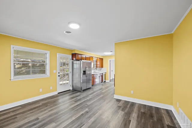 a kitchen with stainless steel appliances granite countertop a refrigerator and a stove top oven