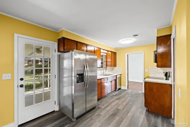 a view of a kitchen with a sink and a refrigerator