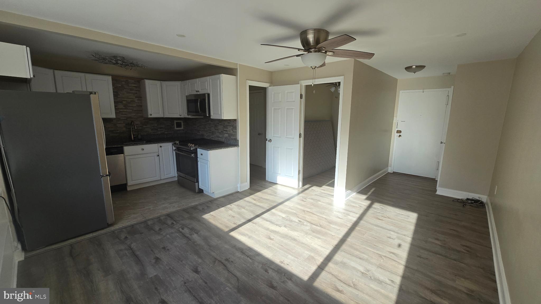 1121 Arlington Boulevard, Unit 801 Arlington, VA 22209 - Photo 13 of 14 a kitchen with stainless steel appliances granite countertop a refrigerator and a sink