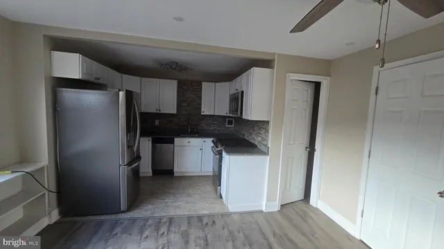 a kitchen with a refrigerator and a sink