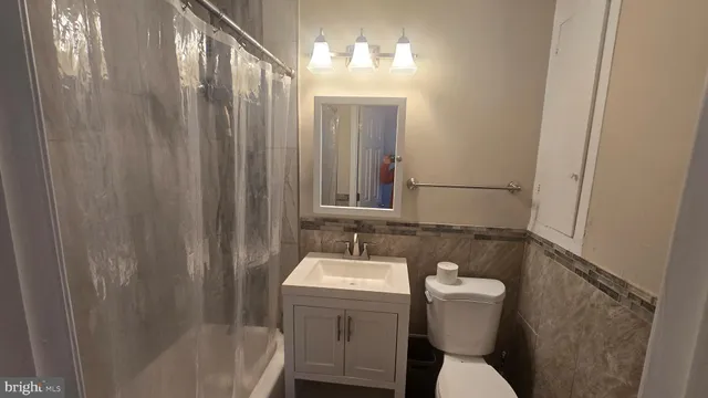 a bathroom with a sink a toilet a mirror and vanity
