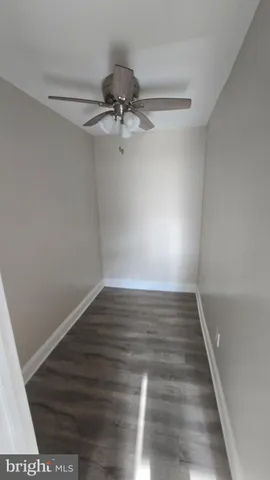 a view of room with hardwood floor and ceiling fan