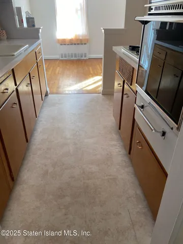 a view of a kitchen with furniture and a window