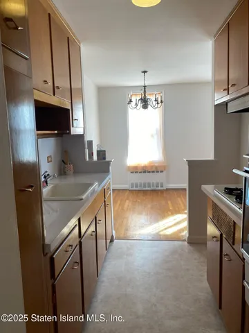 a kitchen with stainless steel appliances granite countertop a sink a stove and a refrigerator