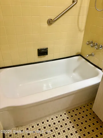 a bathroom with a bathtub and shower