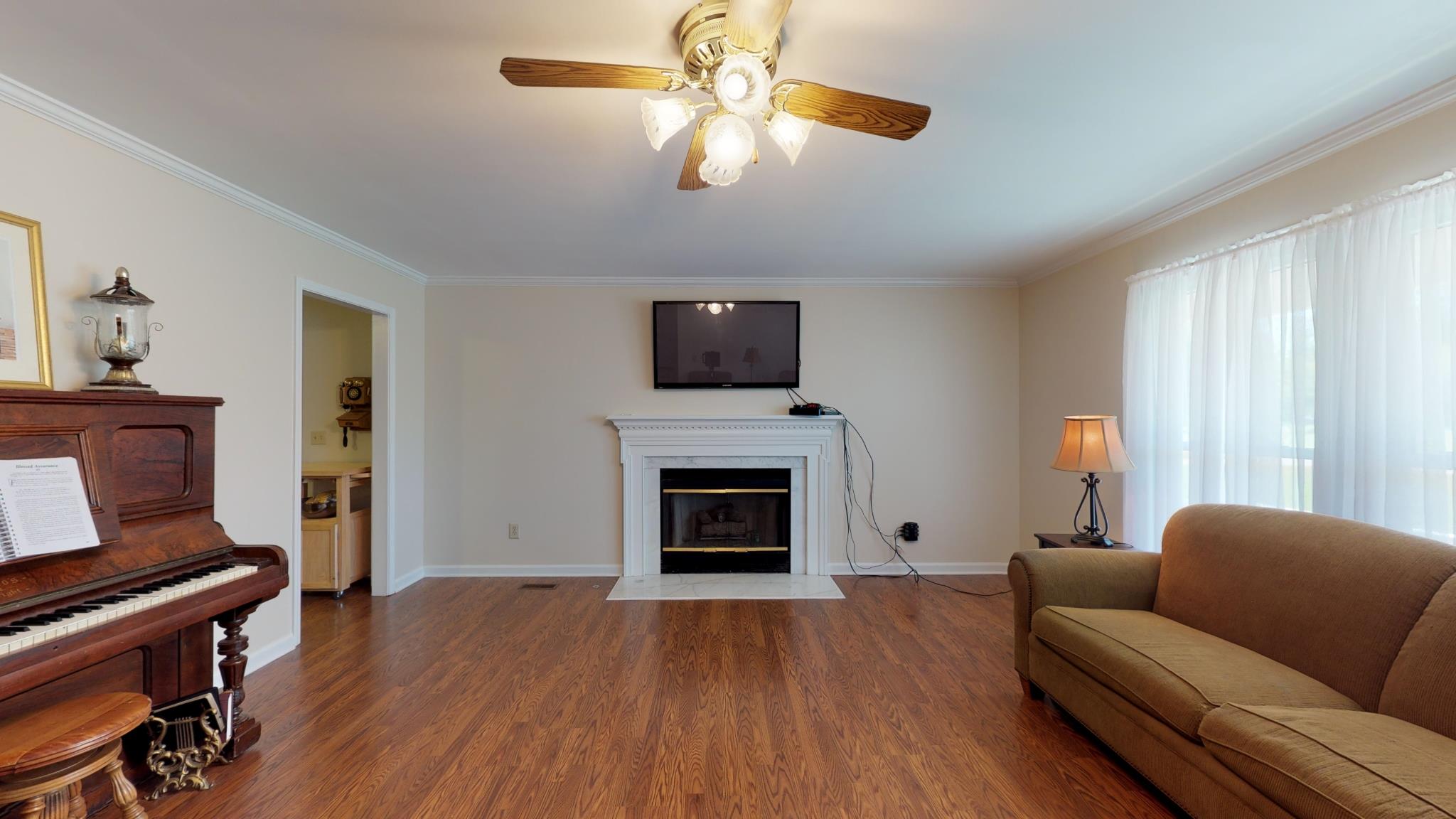101 Raspberry Lane Smyrna, TN 37167 - Photo 5 of 30 Living room features a gas fireplace, crown molding and wood floors! 101 Raspberry Ln, Smyrna, TN 37167