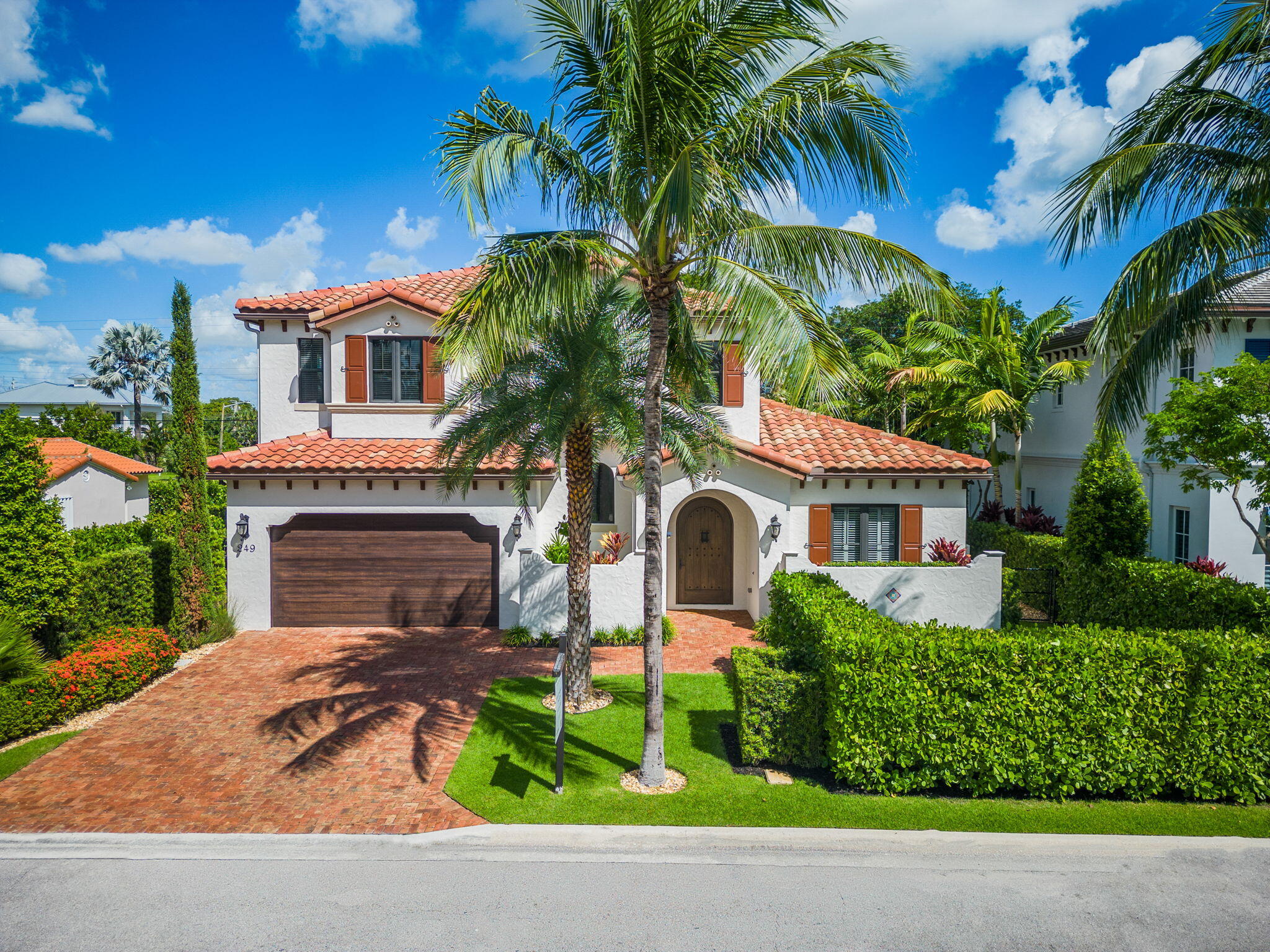 a front view of a house with a garden