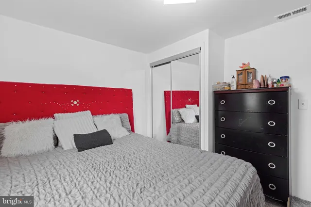 a bedroom with a bed and a closet