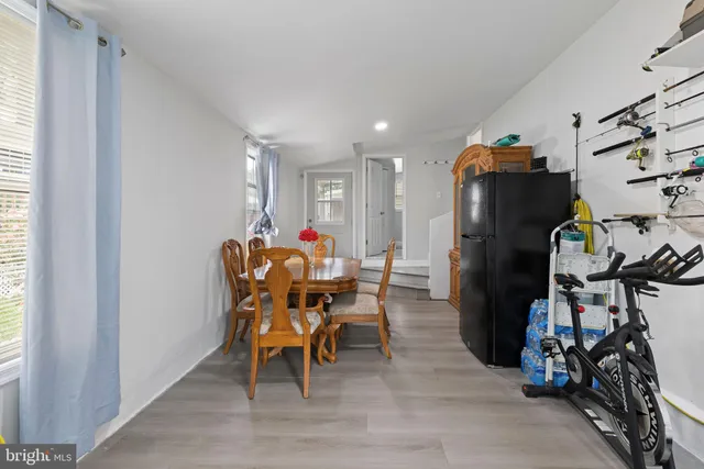 a dining room filled with furniture and a gym machine