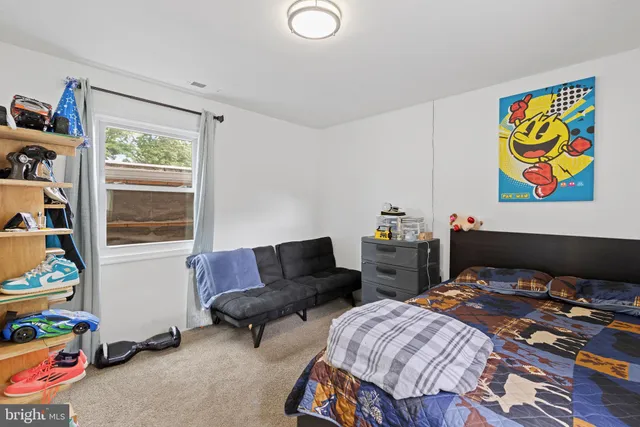 a bedroom with furniture and a window