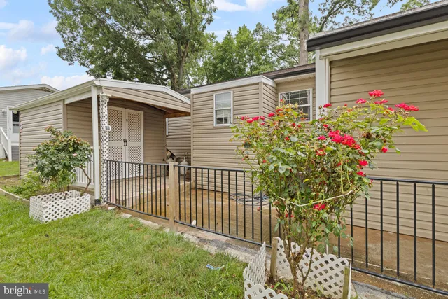 a view of a chair and table in the back yard of the house