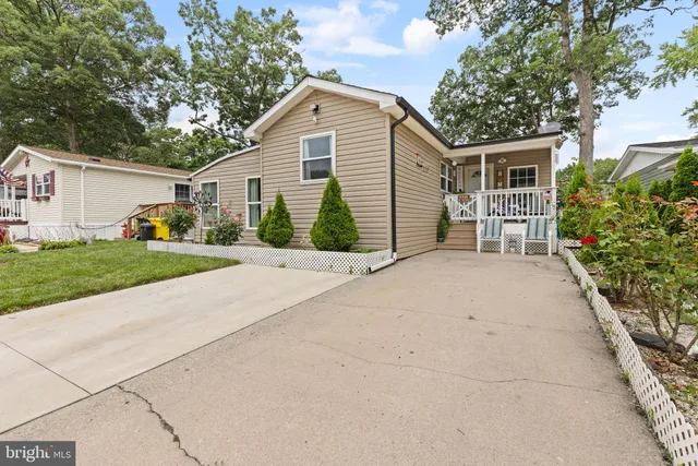 a view of a house with a yard and potted plants