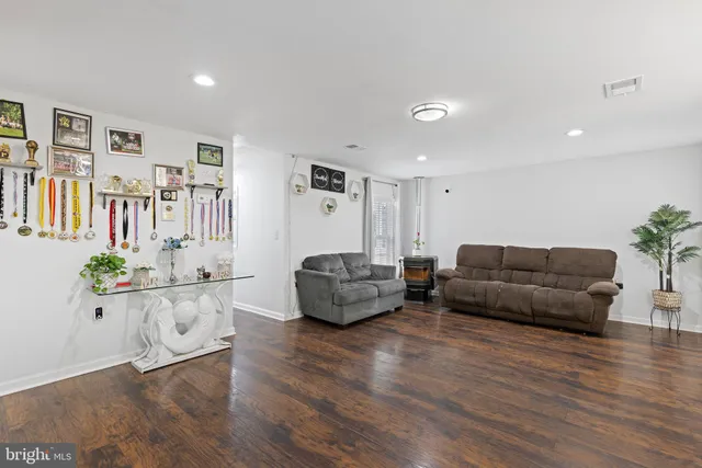 a living room with furniture and wooden floor