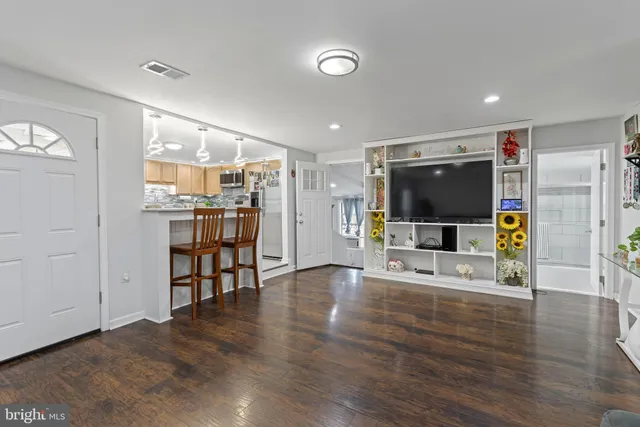 a view of a livingroom with furniture wooden floor and window