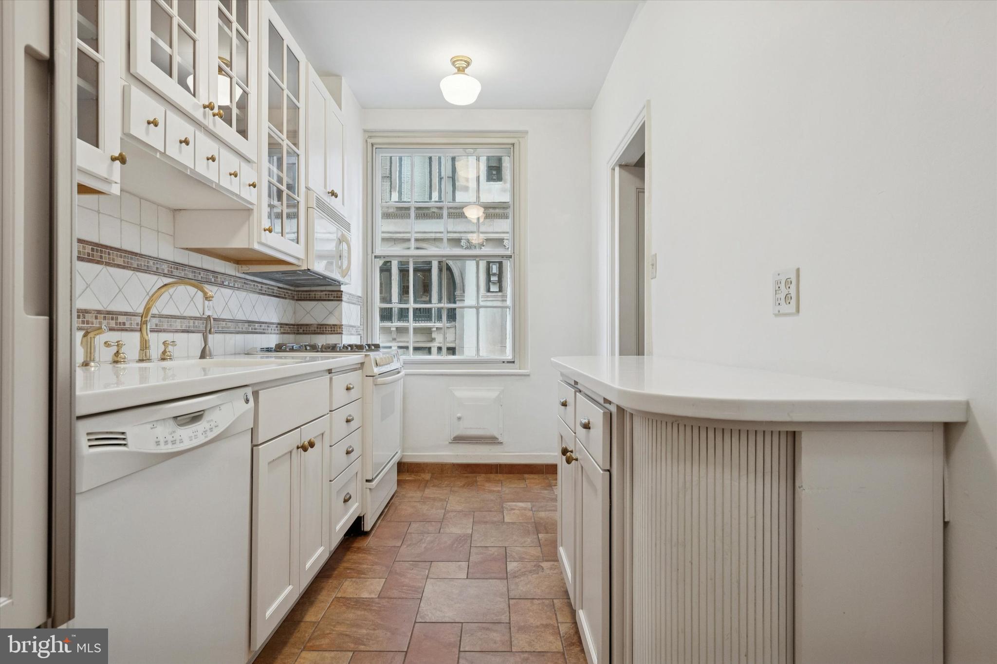 1900-00 Rittenhouse Square, Unit 3C Philadelphia, PA 19103 - Photo 14 of 25 a kitchen with granite countertop a sink and cabinets