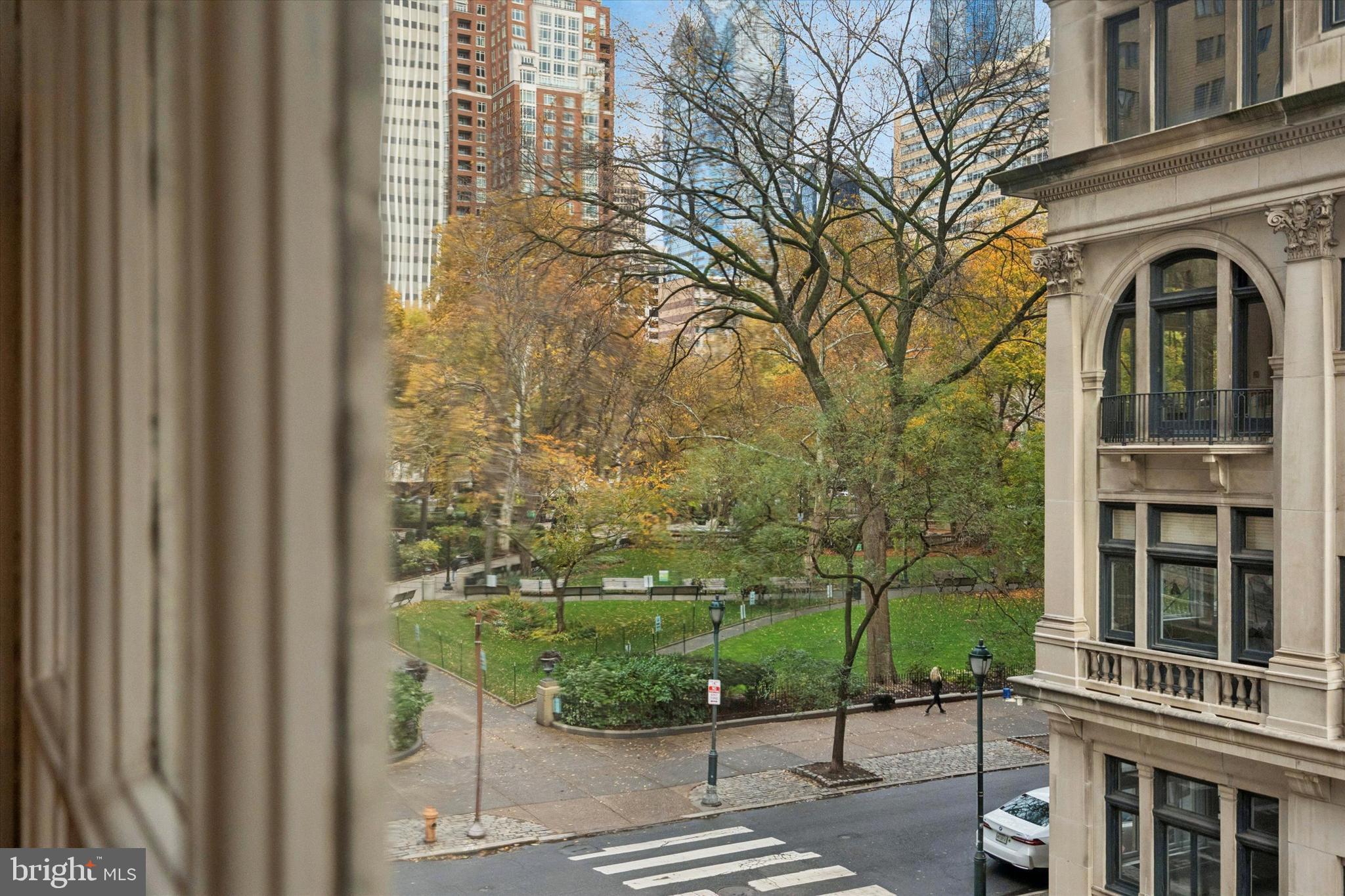 1900-00 Rittenhouse Square, Unit 3C Philadelphia, PA 19103 - Photo 16 of 25 a view of a brick house with many windows next to a yard