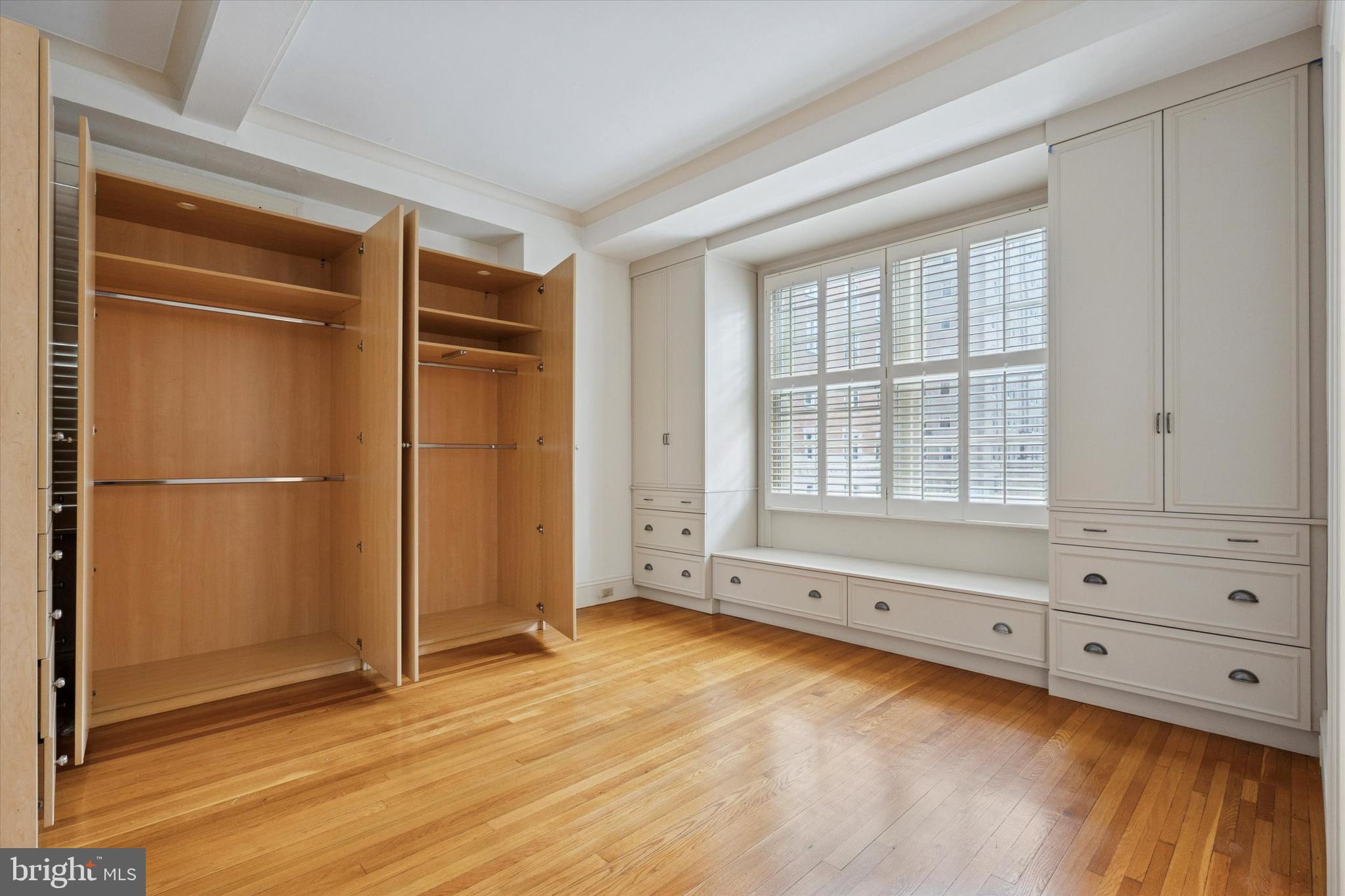 1900-00 Rittenhouse Square, Unit 3C Philadelphia, PA 19103 - Photo 17 of 25 a view of an empty room with wooden floor and cabinet