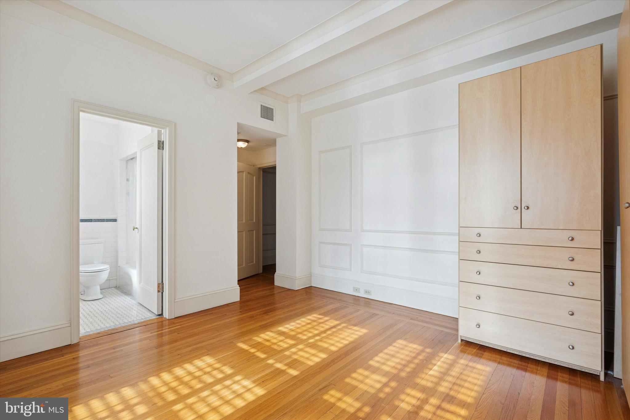 1900-00 Rittenhouse Square, Unit 3C Philadelphia, PA 19103 - Photo 19 of 25 a view of a bedroom with wooden floor and cabinet