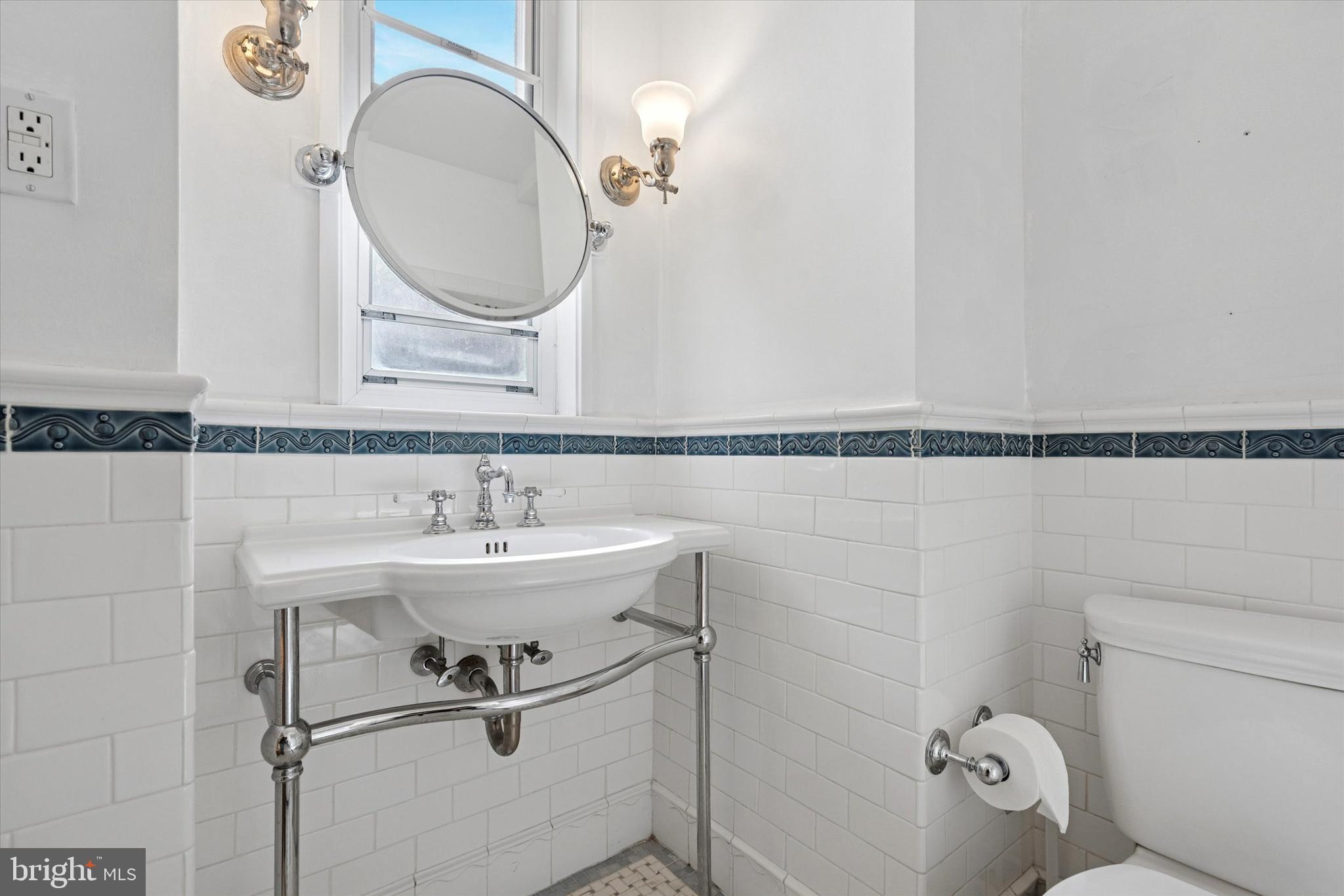 1900-00 Rittenhouse Square, Unit 3C Philadelphia, PA 19103 - Photo 20 of 25 a bathroom with a sink a toilet and a mirror