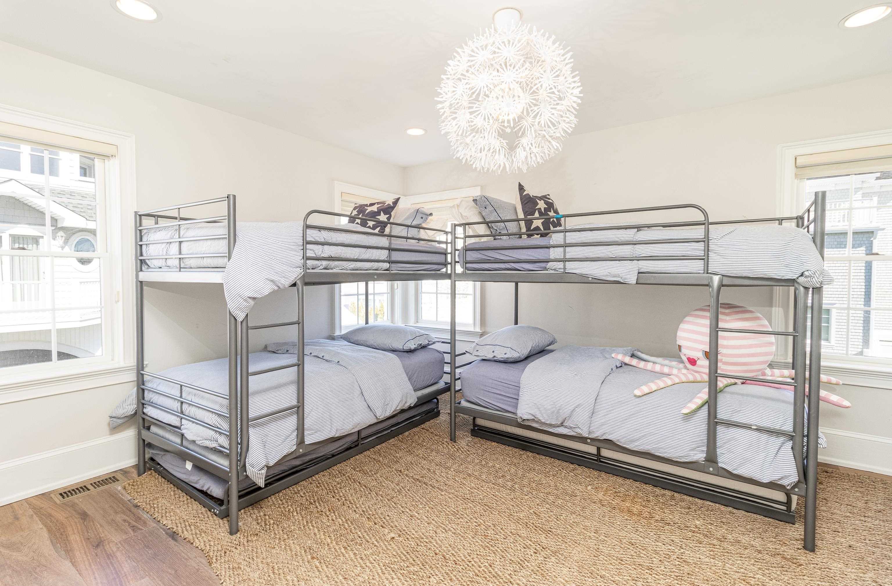 153 76th Street Avalon, NJ 08202 - Photo 14 of 33 a bedroom with bed and a chandelier