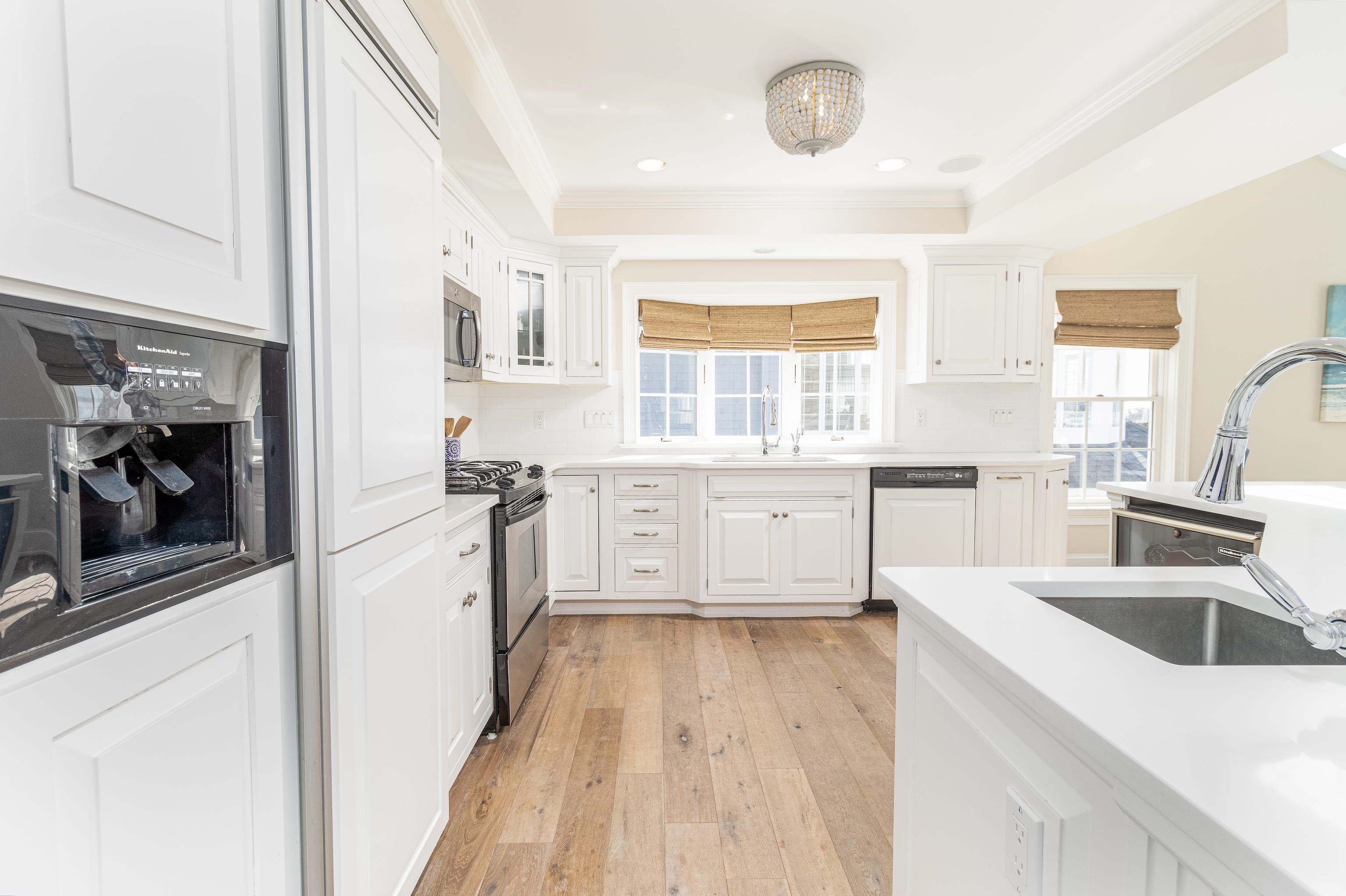 153 76th Street Avalon, NJ 08202 - Photo 18 of 33 a kitchen with a sink a counter top space stainless steel appliances and a window