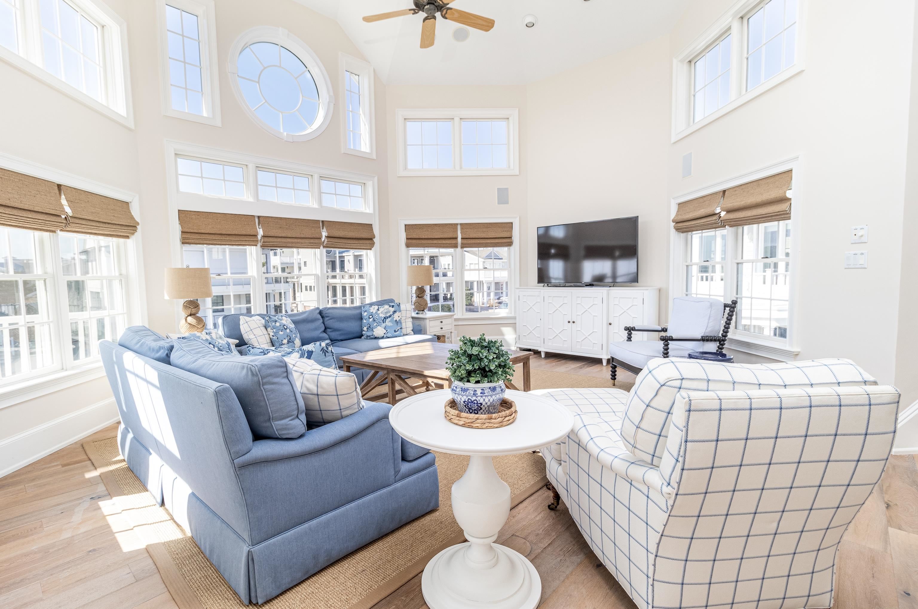 153 76th Street Avalon, NJ 08202 - Photo 21 of 33 a living room with furniture a flat screen tv and a large window