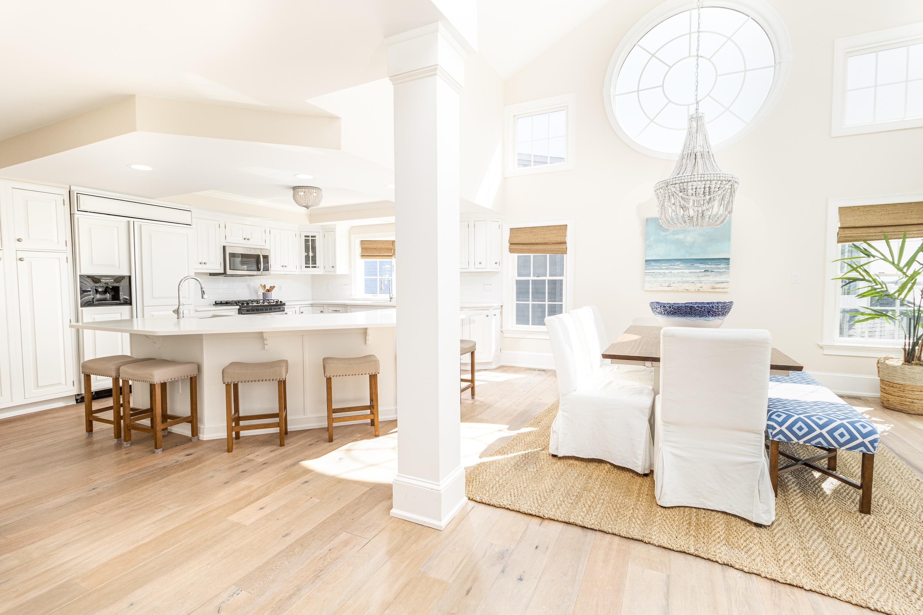 153 76th Street Avalon, NJ 08202 - Photo 23 of 33 a living room with kitchen island furniture and a chandelier