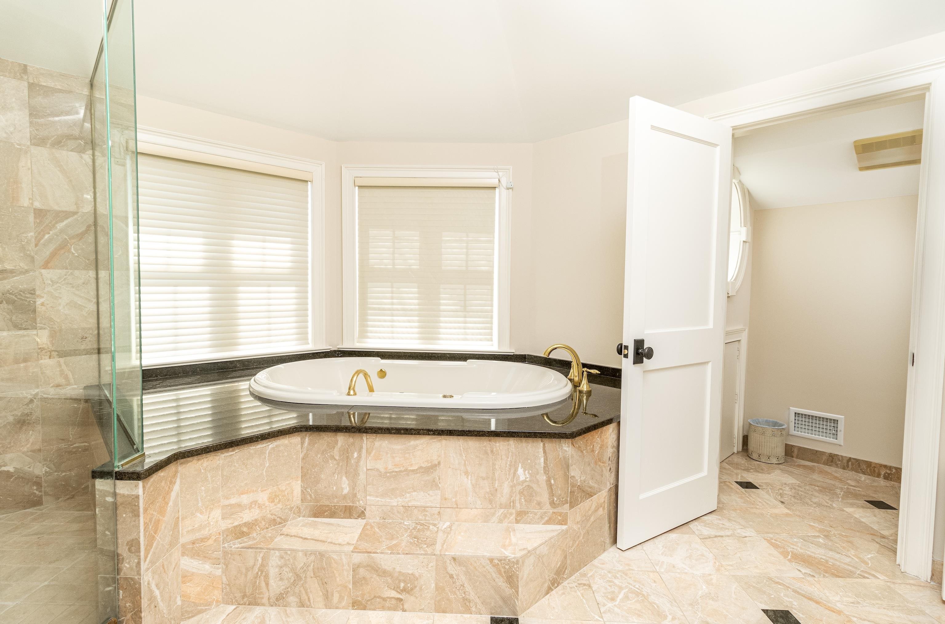 153 76th Street Avalon, NJ 08202 - Photo 31 of 33 a bathroom with a granite countertop sink and a mirror