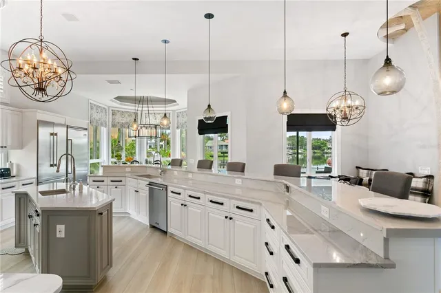 a kitchen with white cabinets and appliances