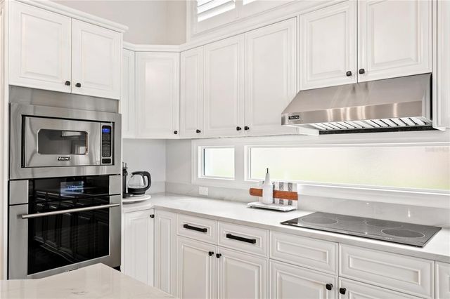 a kitchen with a cabinets and a stove top oven