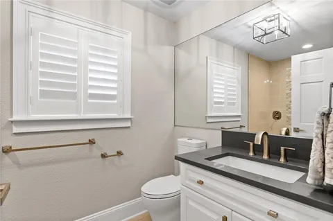 a living room with furniture tv and a large window