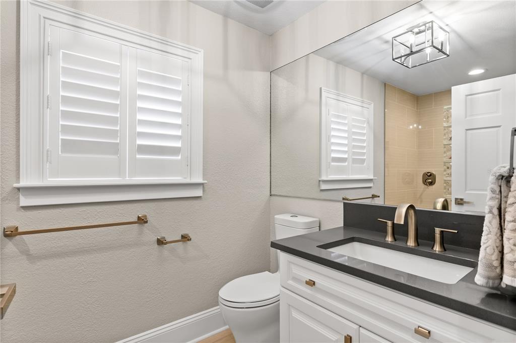 420 Coffee Pot Riviera Northeast St. Petersburg, FL 33704 - Photo 24 of 55 a bathroom with a granite countertop toilet a sink and a mirror