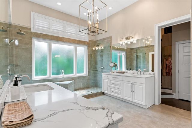 a bathroom with a double vanity sink window and a mirror