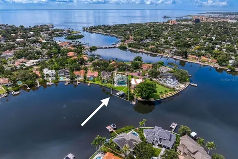 an aerial view of a house with a lake view