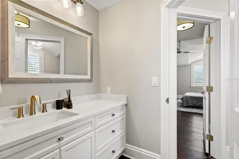 a kitchen with kitchen island a sink wooden floor and a large window