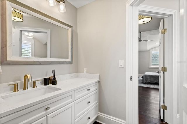 a kitchen with kitchen island a sink wooden floor and a large window