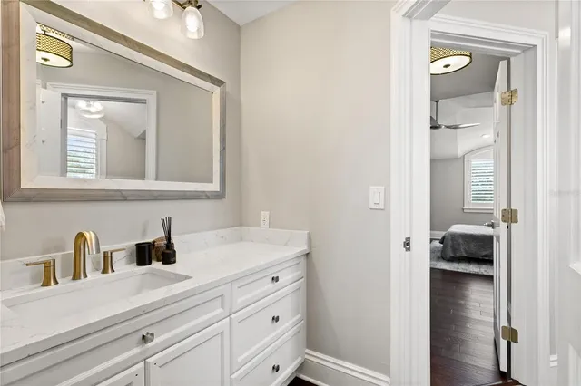 a kitchen with kitchen island a sink wooden floor and a large window