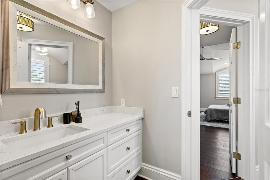 420 Coffee Pot Riviera Northeast St. Petersburg, FL 33704 - Photo 36 of 55 a en suite bathroom with a sink a vanity and mirror