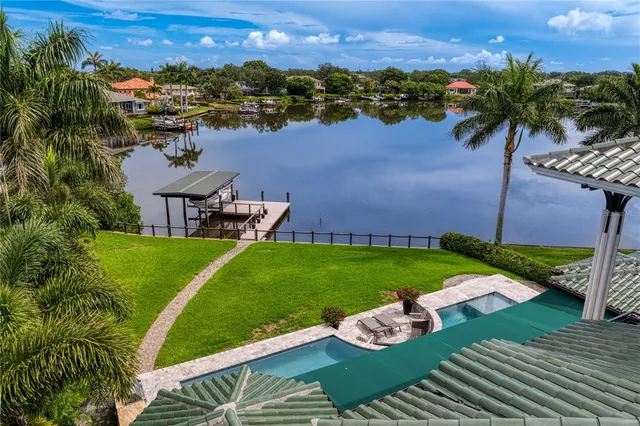 a view of a lake with a garden and houses