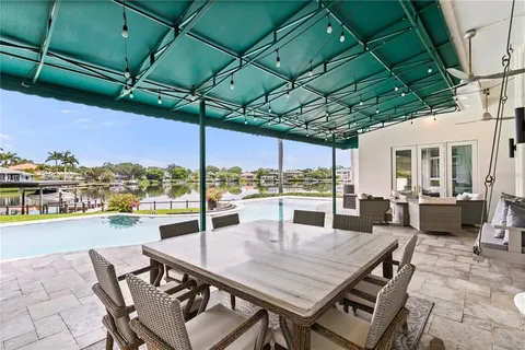 an aerial view of residential houses with outdoor space and swimming pool