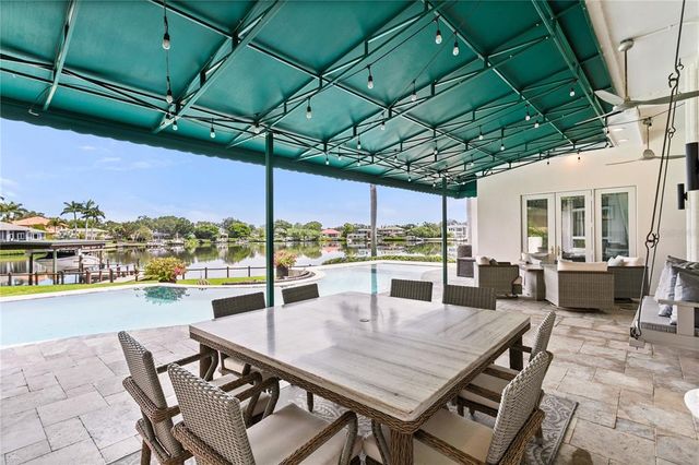 an aerial view of residential houses with outdoor space and swimming pool