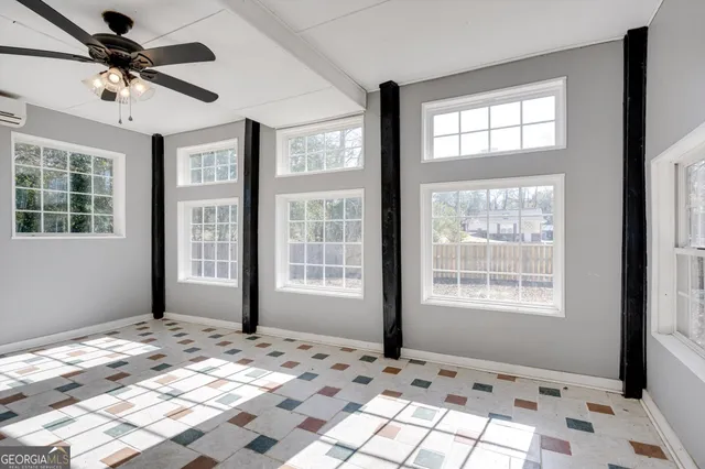 a view of a bedroom with a bed wooden floor and a window