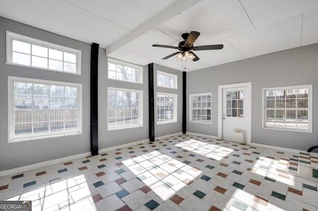 a kitchen with granite countertop a refrigerator sink and cabinets